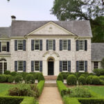 White limewash brick home exterior with a soft, natural mineral finish and subtle brick texture showing through.