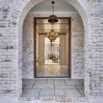 White limewash brick home exterior with a soft, natural mineral finish and subtle brick texture showing through.