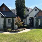 Limewashed brick exterior applied by a professional contractor for a soft, natural patina and cohesive finish.